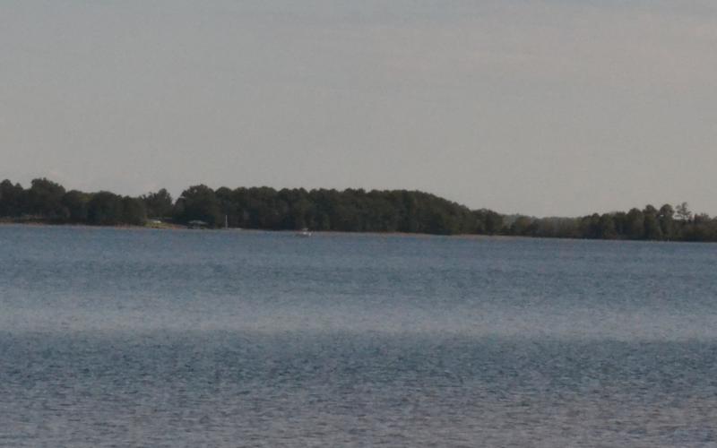 A boat rests far in the distance on Lake Hartwell on Monday morning at the location of a plane that crashed Saturday. Photo taken from Carter's Ferry. (Dan Hunt/The Hartwell Sun] 