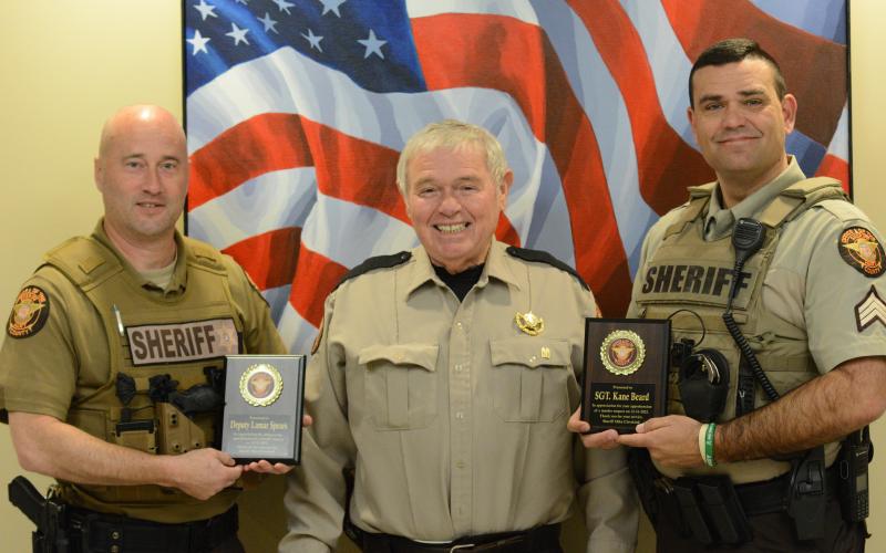 Hart County deputy Lamar Spears (left) and Sgt. Kane Beard (right) are awarded plaques from sheriff Mike Cleveland for their roles in the arrest of Andrew Nicholas Berry, who is accused of killing his girlfriend on Dec. 31.