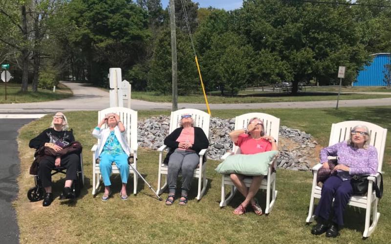 Residents at Brookdale in Hartwell take in the solar eclipse from their rocking chairs. Pictured from left is Nancy Strong, Phyllis Burton, Doris Ford, Gail Manter, and Ophelia Brown.