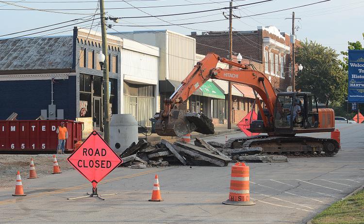 Sunshot by Michael Hall — Heavy machinery breaks up the asphalt at the corner of Forest Avenue and Depot Street on Tuesday as work continues on a major infrastructure improvement project underneath Depot Street. 