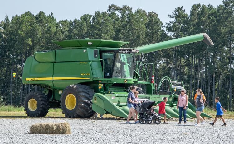Visitors convene in front of one of the many examples of heavy machinery at this weekend’s Ag Expo.