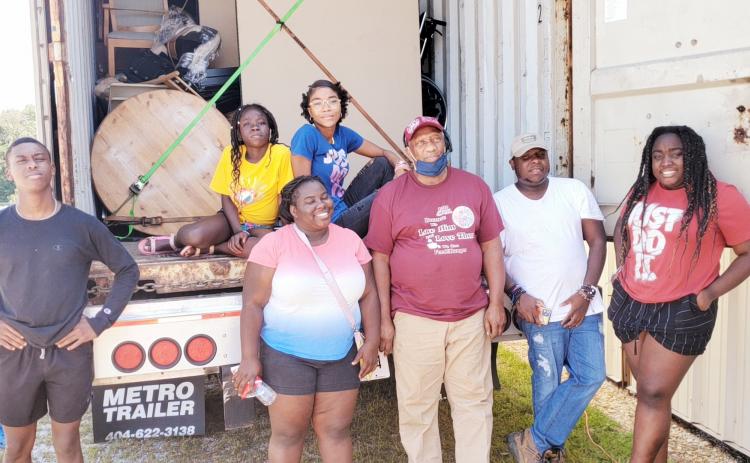Volunteers in Lavonia on Saturday load a truck full of supplies for Haitians in need after last month’s earthquake. From left to right are Fred, Mirlanda, Belinda, Samaika, Willy (truck driver), Samuel and Redaphca.  All are students at Barnes  Academy, with the exception of Willie, a pastor from Alabama, and Samuel who is in college.