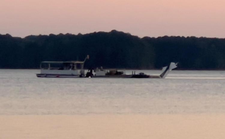 Authorities working with a professional dive team retrieve Carrell's body and plane in Lake Hartwell.