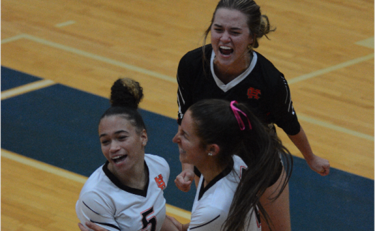 Pictured from left to right are seniors Kiera Jester, Lillie Kate Rogers, and Abby Hubbard celebrating a set win, as the Volley Dogs advanced to the Elite Eight after back-to-back sweeps over Cedar Grove and LaFayette High School.