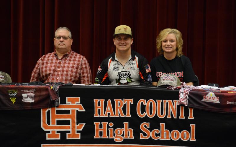 Austin McCall (middle) signs with USC-Union on a fishing scholarship.