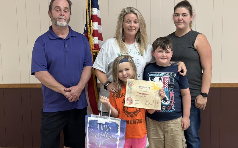 The Bowersville City Council presented the winner of the Georgia Cities Week coloring contest with a certificate and a gift bag at their May 16 meeting. Pictured left to right: Mayor John Smith; council member Alicia Barnett with winner Xavi Farmer and Farmer’s brother, Koda Phillips; and the children’s mother, Cheyenne Phillips. 