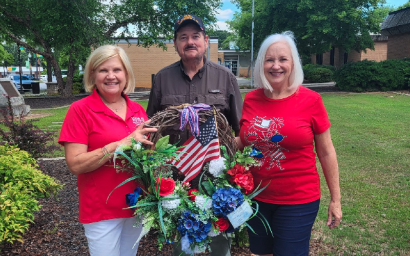 Left to right: Beth Mewborn Commander James Fulghum American Legion post 109, Jeanne Alpers Service League ladies put a wreath at the WWII Monument for Memorial Day.