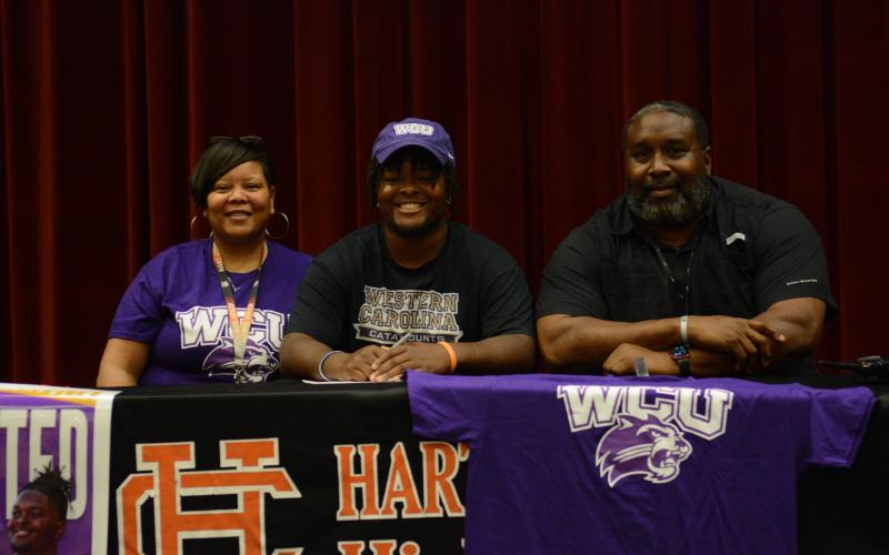 Trez Fouch (middle) signs with Western Carolina University to compete in track and field.