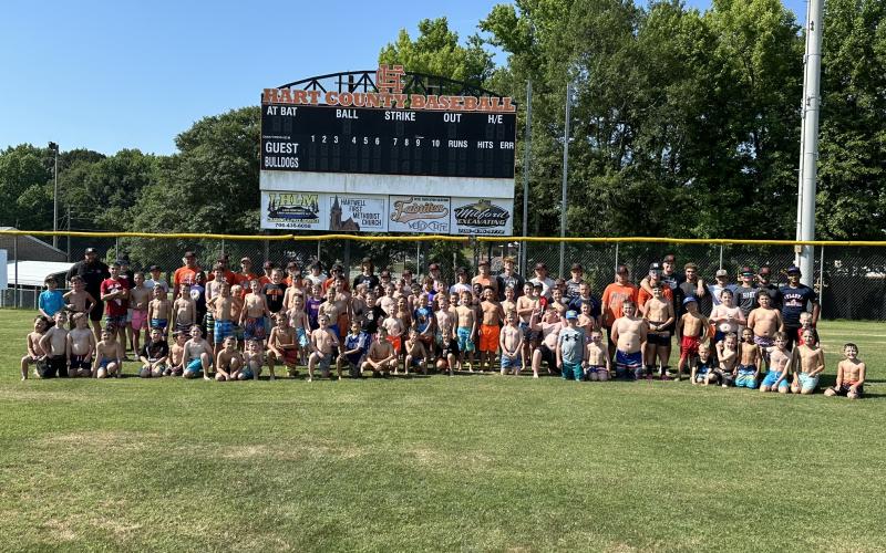 Pictured are campers, players, and coaches from Hart County Middle and High School posing for a group photo after spending time on a water slide to end their annual youth camp. 