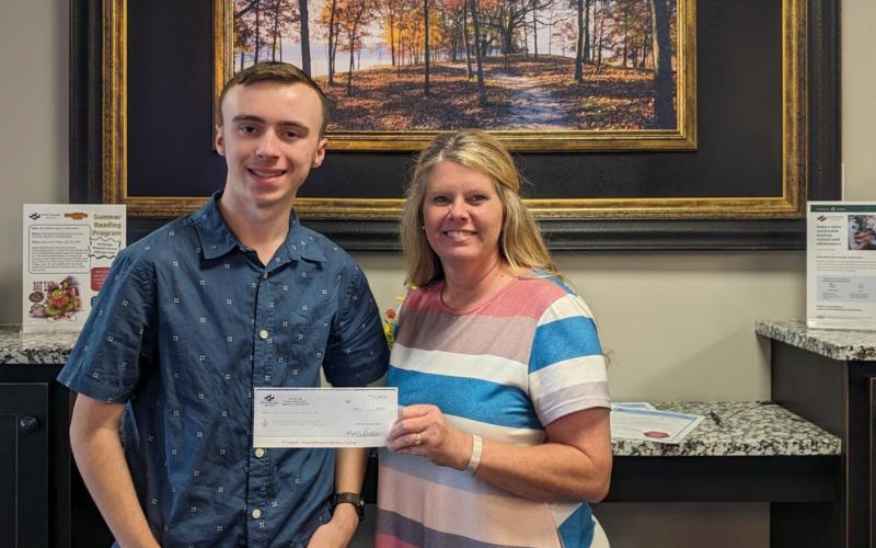 Hart County Senior Sawyer Strickland receives a scholarship check from Kim Little at North Georgia Credit Union 